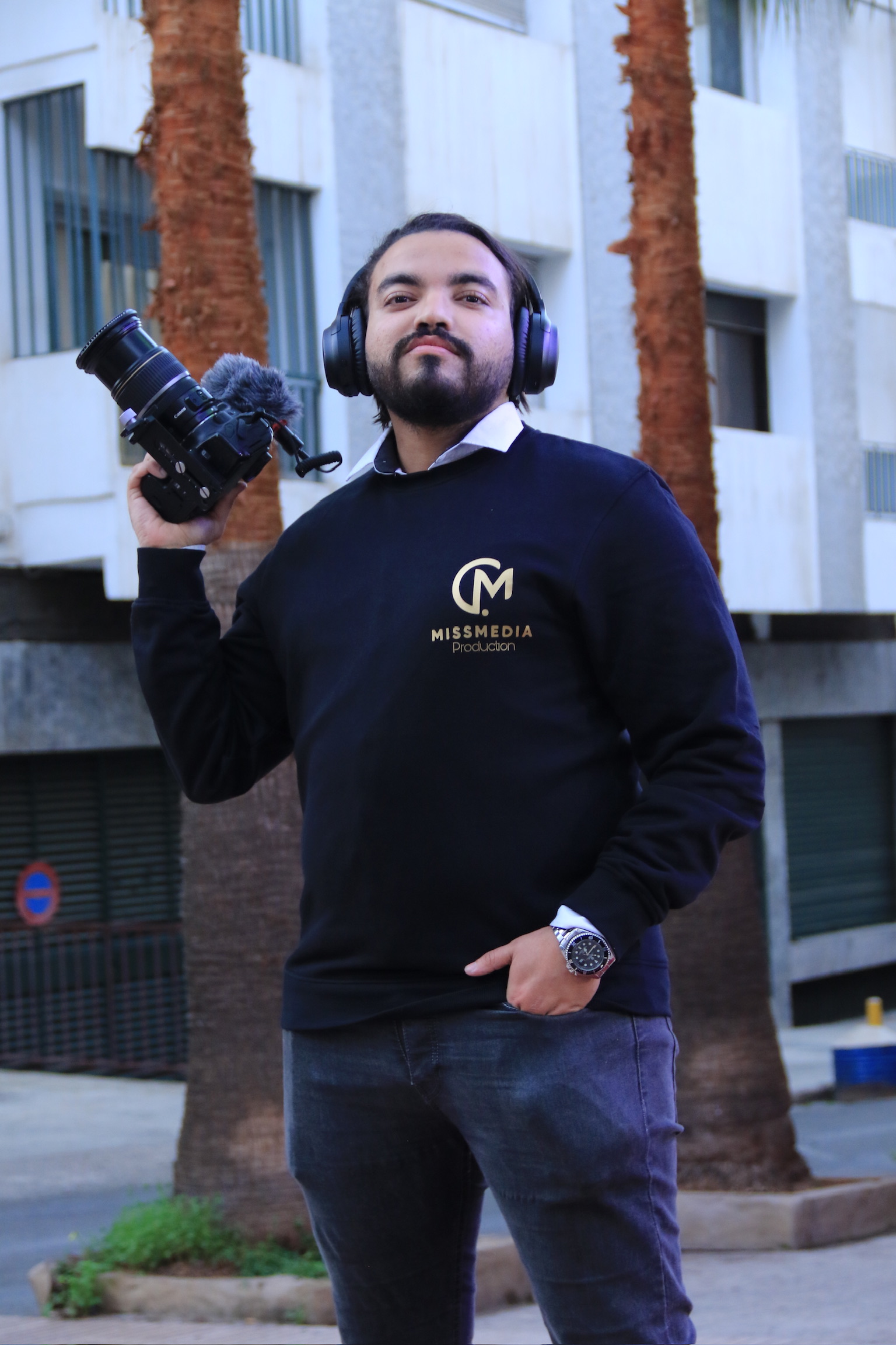 Mohamed Amine Missaoui with professional camera equipment in a bright outdoor setting, demonstrating technical expertise