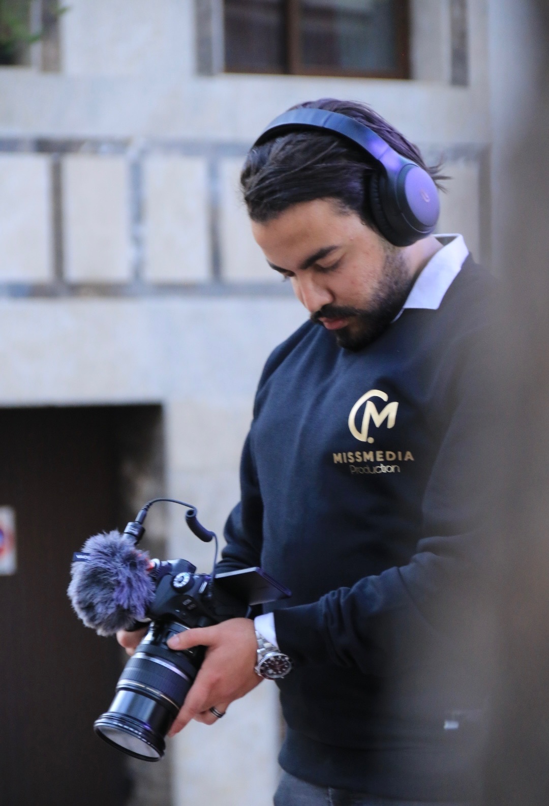 Mohamed Amine Missaoui operating a professional drone for aerial cinematography in an outdoor location, natural daylight, professional gear visible
